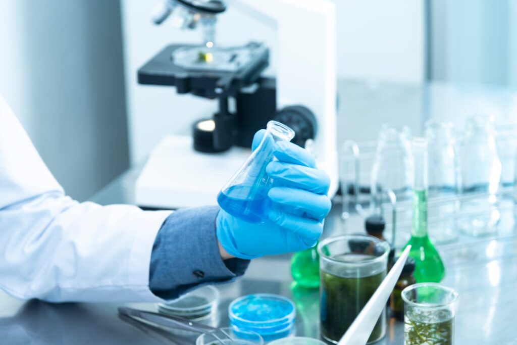 person in a lab holding a beeker